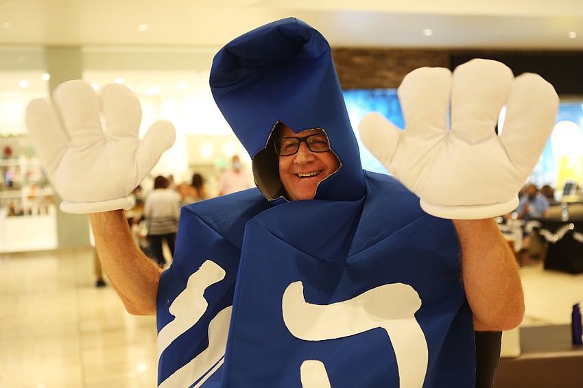 David Stein welcomes visitors while dressed as a dreidel.