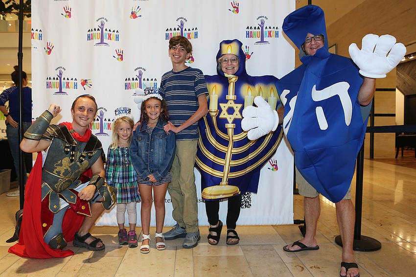 Eliza, Marin and Jackson Mitchell pose with the event's costumed characters.