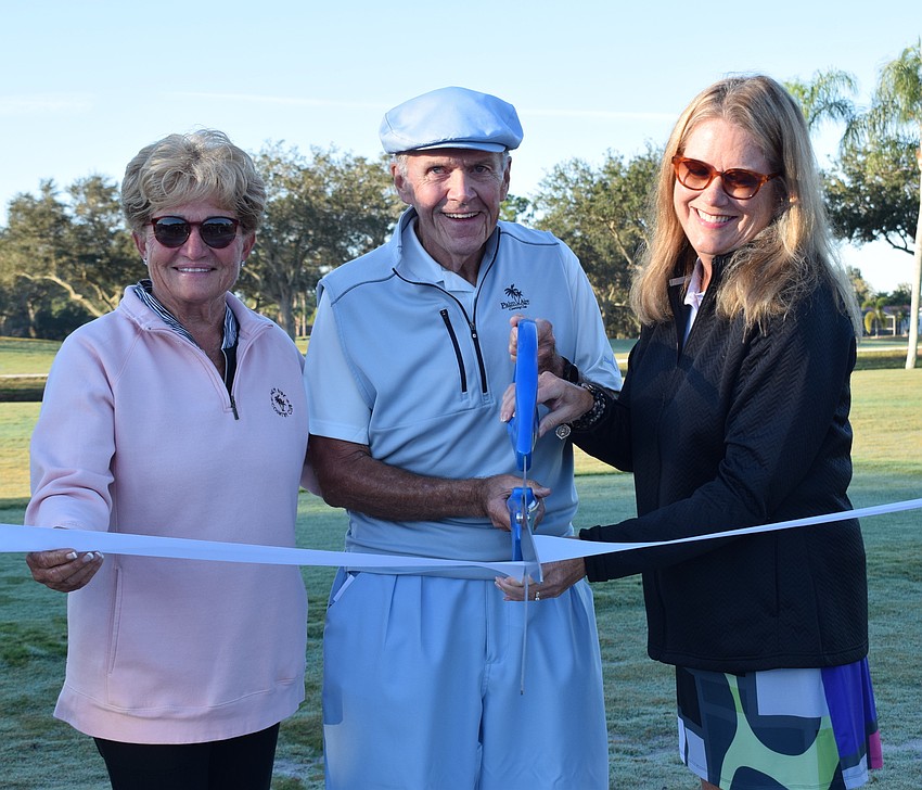 Palm Aire Country Club Board Member Vicki DeHaai, Board President Bernie Duggan and Vice President Marilyn Keyes cut the ribbon to open the course.