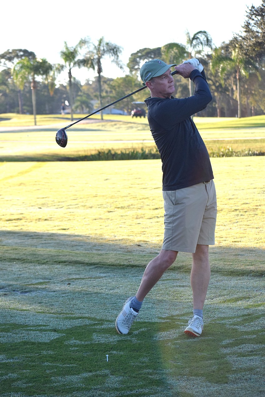 Golf course architect Michael Benkusky hits a ceremonial shot. The members were thrilled with Benkusky's renovation.