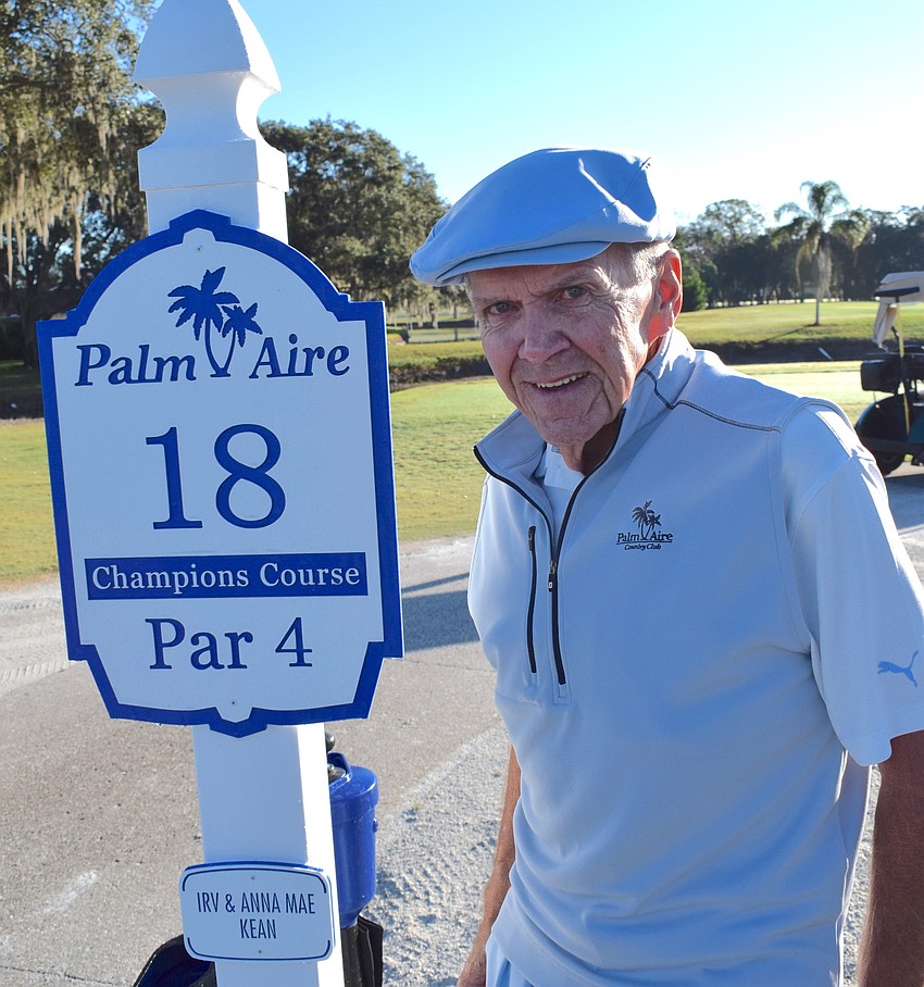 Markers on every hole honor residents or sponsors, such as on No. 18. Board President Bernie Duggan stands next to a sign that honors Irv and Anna Mae Kean.
