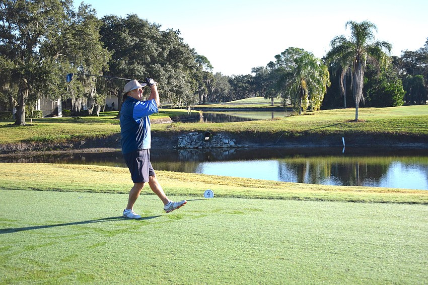 Bill Wachter does a little dance after hitting off the tee at No. 18.