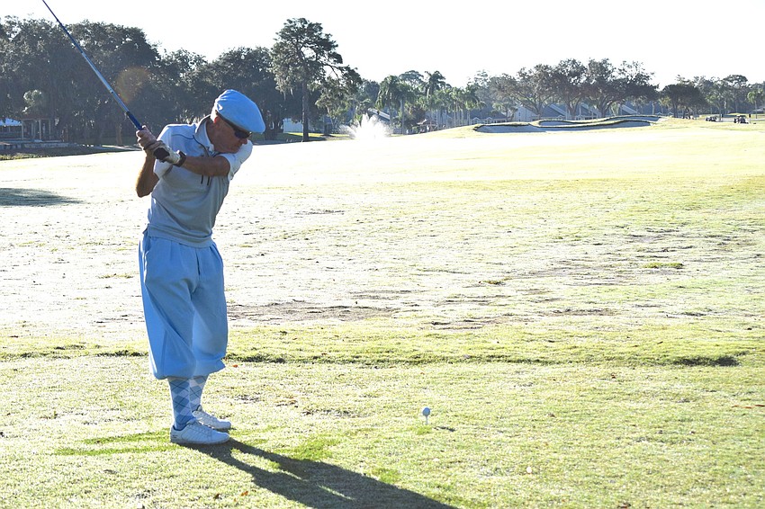 Palm Aire Country Club Board President Bernie Duggan goes into his backswing to drive the ball down the fairway.