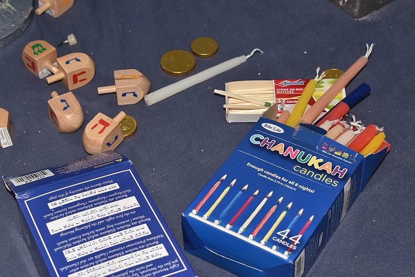 The menorah table was scattered with extra candles and dreidels.