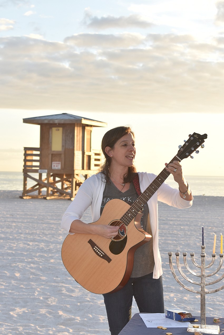 Barbara Mazer led the attendees in several Hanukkah songs.