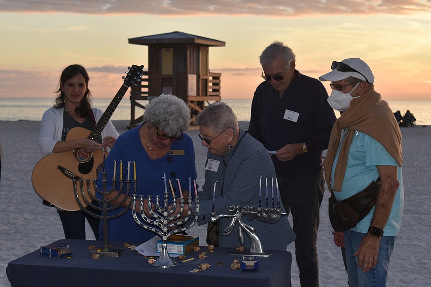 Lighting the menorahs in the evening breeze proved to be harder than it looked.