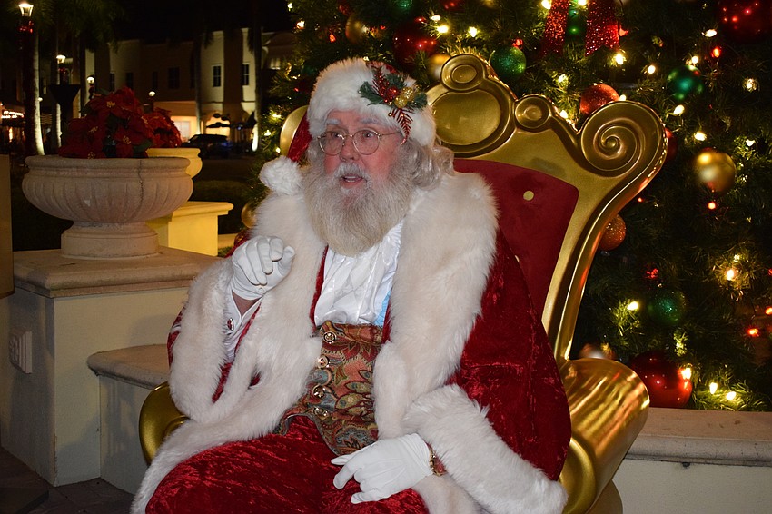 Santa greets families as they line up to visit him on Main Street at Lakewood Ranch.