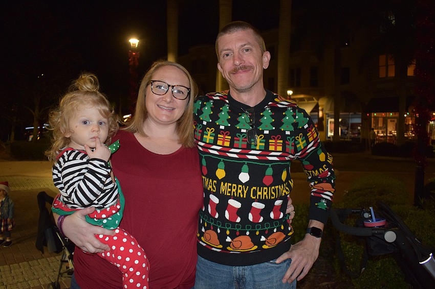 Sarasota's Kaitlyn Milakeve, who is 2 years old, gets into the holiday spirit with her parents, Jessica and Brian Milakeve. They were seeing Santa for the first time this  year.