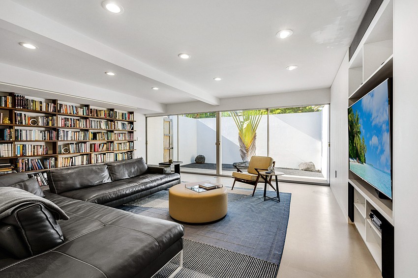 The media room includes a built-in solid walnut bookshelf.