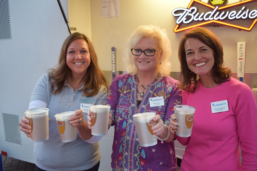 Kelly Gilliland, Nancy Sykes and Nicole Ryskamp serve up beer for the Lakewood Ranch Community Fund, which was Music on Main's featured nonprofit.