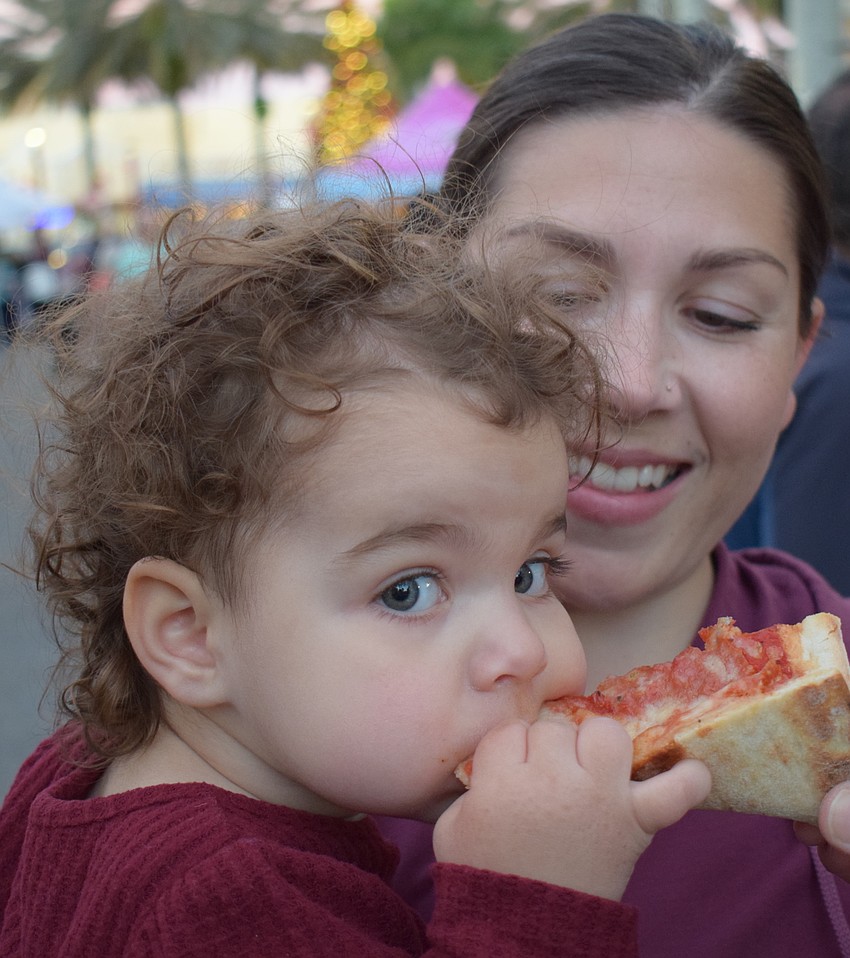 Syracuse, New York's Liv Pucello, 17 months, loves her pizza from Main Street Trattoria. Her mom, Gina Pucello says they are visiting family who live at Lakewood National.