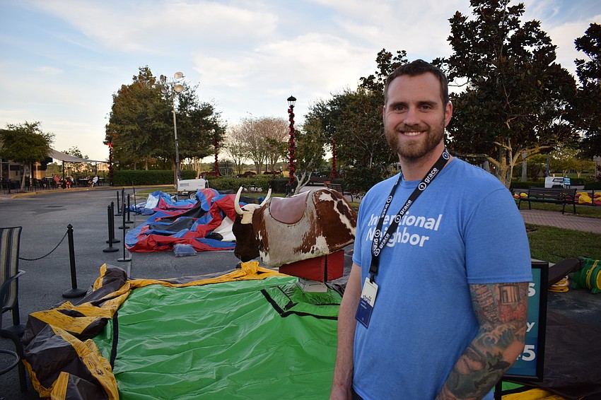 Connor Morehart, the outreach director at Grace Community Church, stands in front of the inflatables before the start of Music on Main. He said Grace Community began sponsoring the kids area at Music on Main about six years ago.