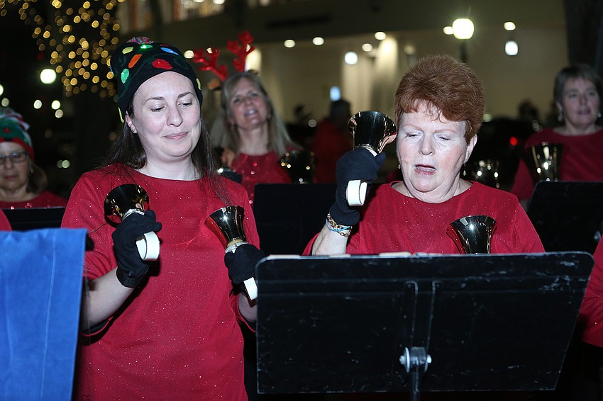 Paige Hunt and Robin Reich ring out Christmas tunes in their Ring Sarasota group.