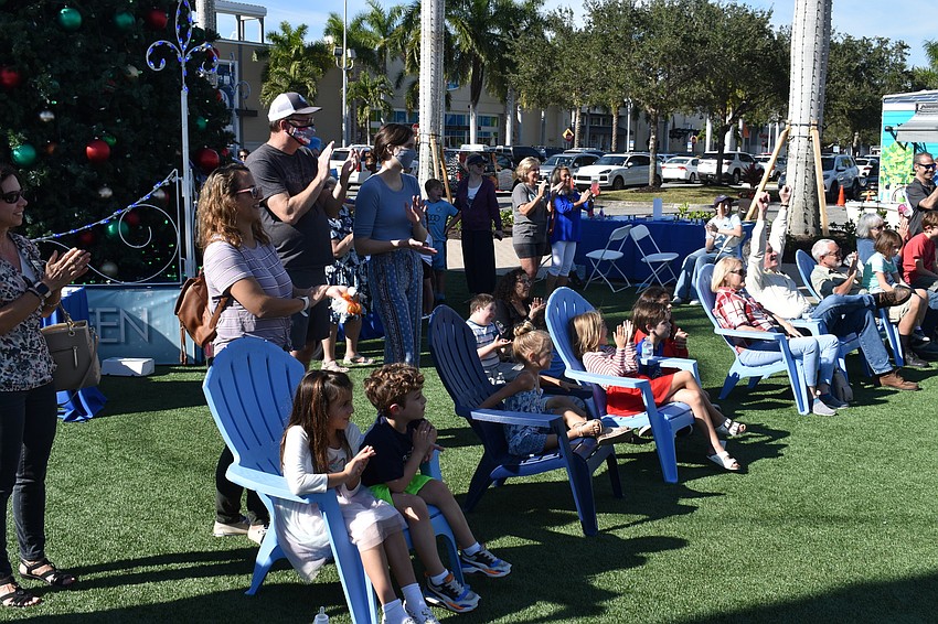 The crowd at Hanukkah at the Green gives Claire Opal-Levine a round of applause at the end of her performance.