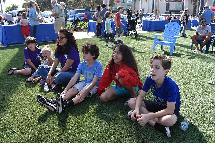 Community Day School students Ari Rahman, Matisse Cantro, Samuel Averbuch, advisor Brenna Wihom, Jay Sweeting and Benjamin Lalo listen to a story.
