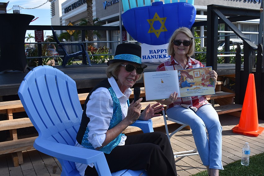 Susan Rosin and Harriett Cohen tell stories during Hanukkah at the Green.
