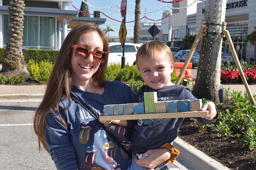 Jen Meeks and Silas Mumford show off their freshly painted menorah.
