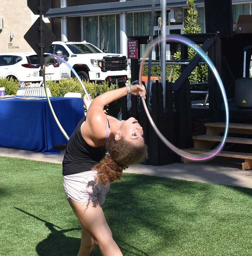 Competitive hula hooper Claire Opal-Levine bends over backwards to entertain the crowd.