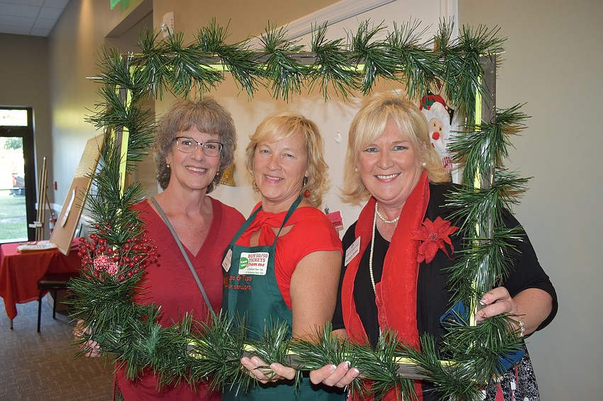Marion Lopata, Ava Fhule and Maribeth Phillips have some fun at the selfie station.