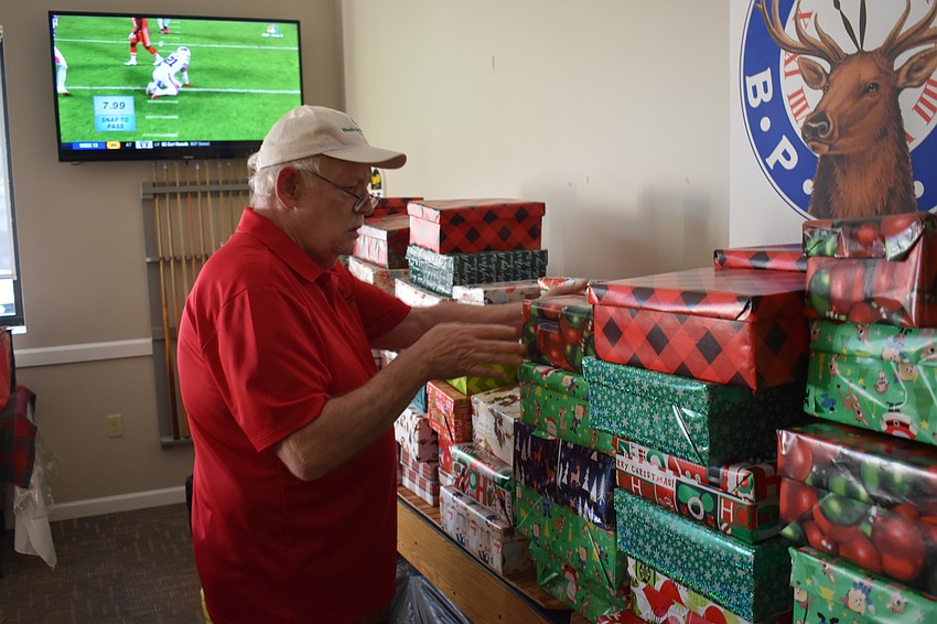 Haskell Gates organizes shoeboxes that had just been donated at the Lakewood Ranch Elks.