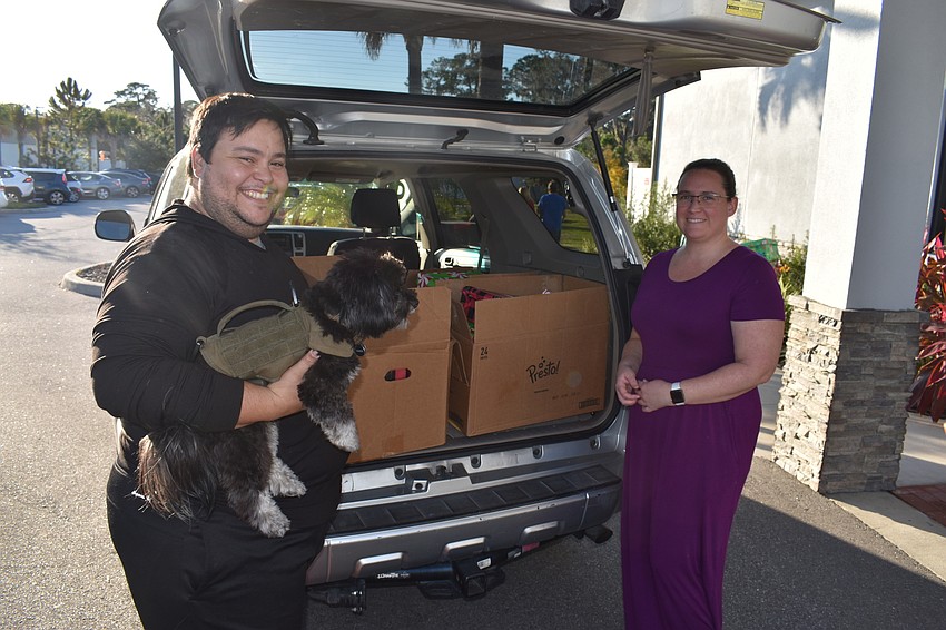 Josue Reyes and Stefanie McCabe drop off a truckload of shoeboxes on behalf of Girl Scouts Troop 140 for the Holiday Shoebox Reception on Dec. 4 at the Lakewood Ranch Elks Lodge.