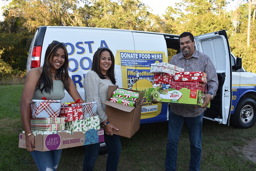 Claudia, Irmarie and Frank Casine load up some of the donated shoeboxes at the Community Holiday Shoebox Drive on Dec. 4 at the Lakewood Ranch Elks Lodge.