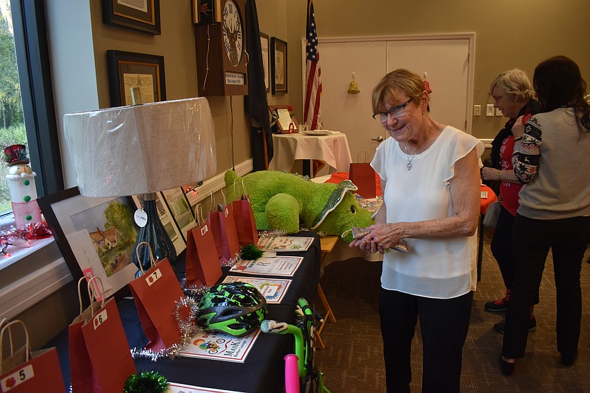 Lakewood Ranch resident Jean Hritz figures out which prize she would like to win in the raffle.