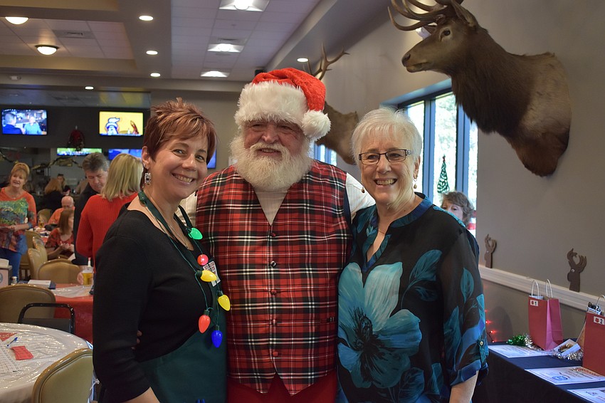 Shawna Hicks-Cranston, Santa (Ron Lee) and Virginia Mitchell enjoy the reception.