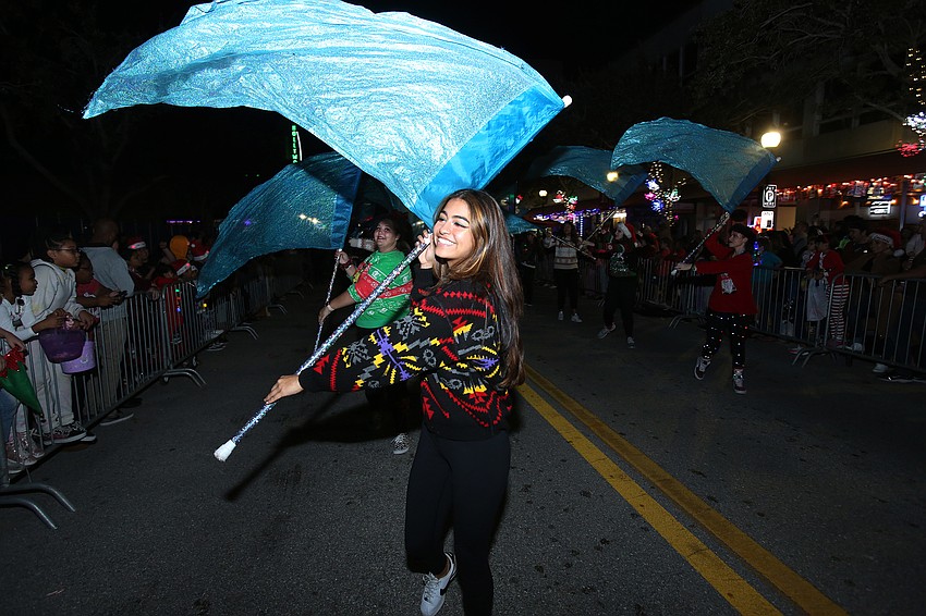 Nicole Llama twirls a flag in the Mighty Sailor band.