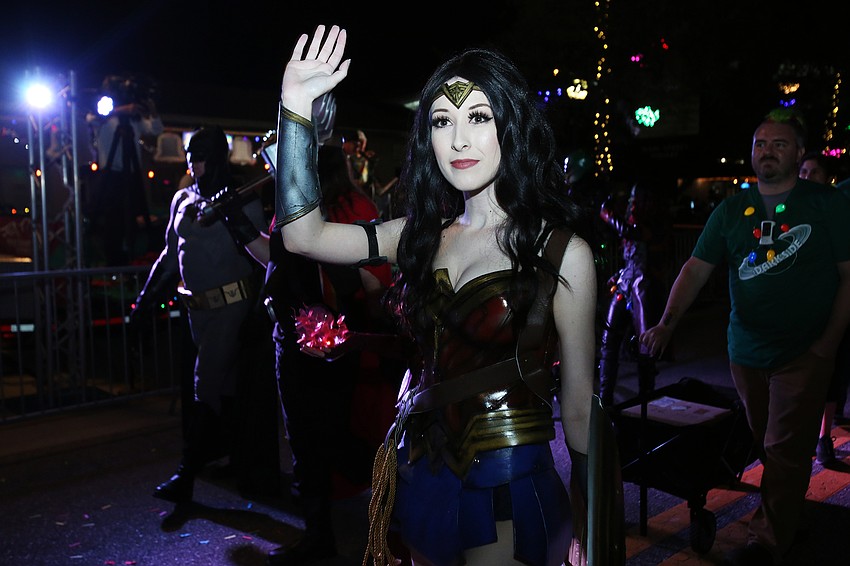 Seneca Puleo as Wonder Woman waves to children.