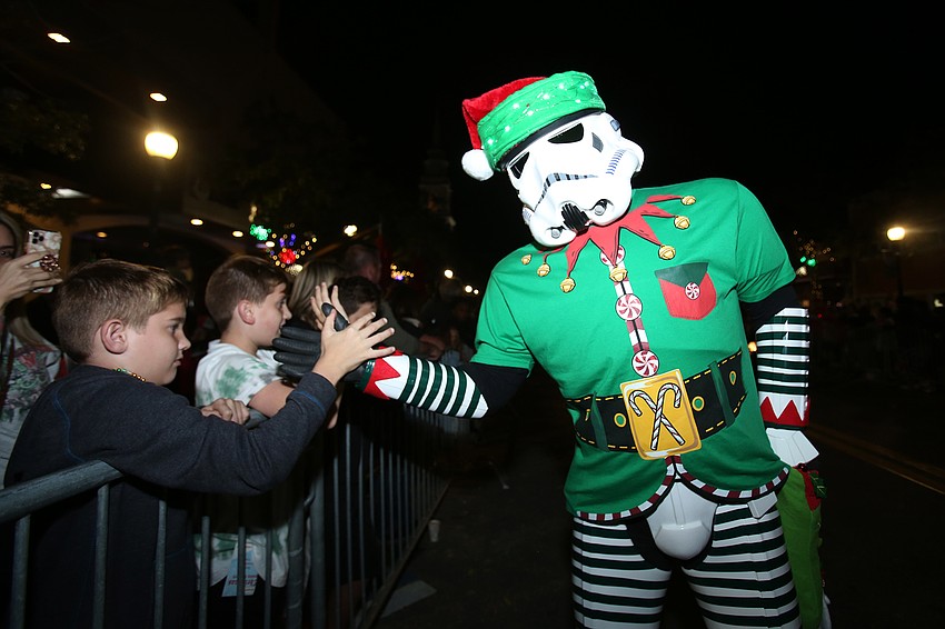 Sean Rankin high fives kids while dressed as a Stormtrooper with the 501st Legion.