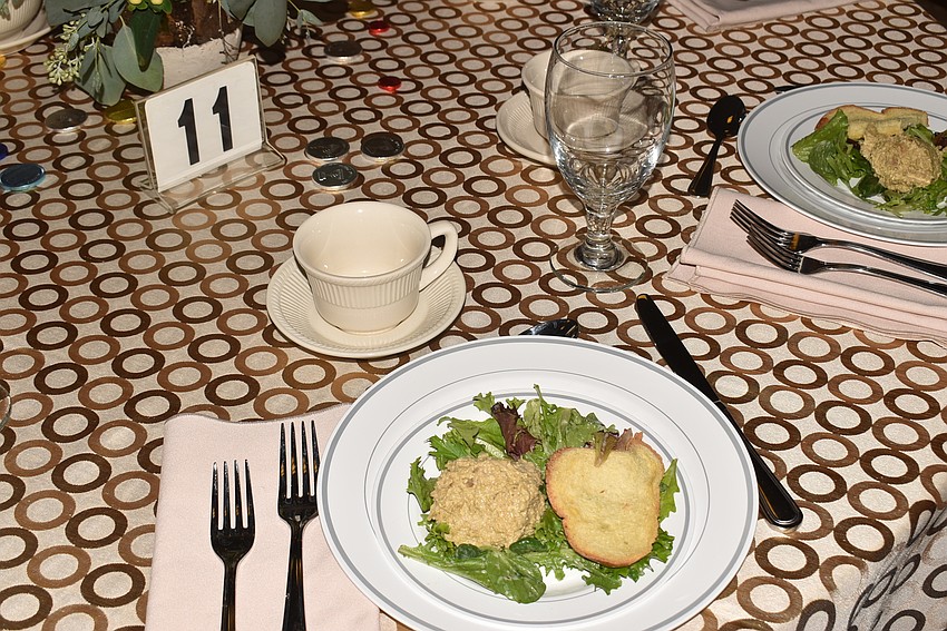 Attendees found their seats and a vegetable course waiting for them.
