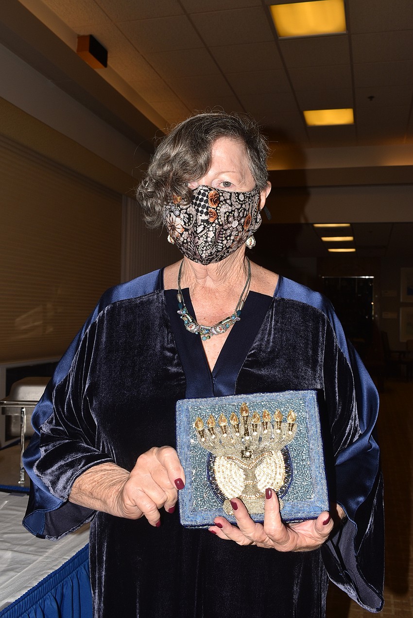 Miriam Goldfarb shows off her menorah handbag. All her accessories came from the BIW Judaica Gift Shop.