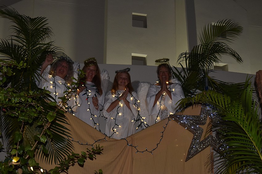 Four angels peer down from the scaffolding at the St. Armands Key Lutheran Church live nativity.