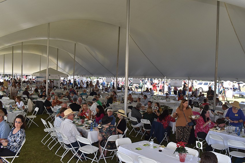 The massive tent seated hundreds of people after they grabbed several plates.