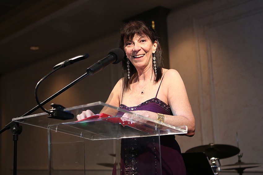 Emcee Cheryl Michel welcomes attendees.