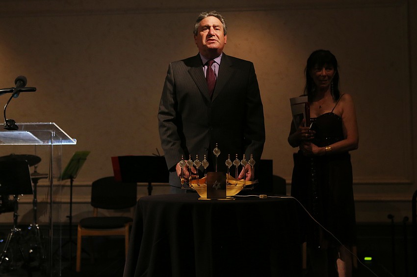 Rabbi Jonathan Katz lights the menorah to celebrate the last night of Hanukkah.