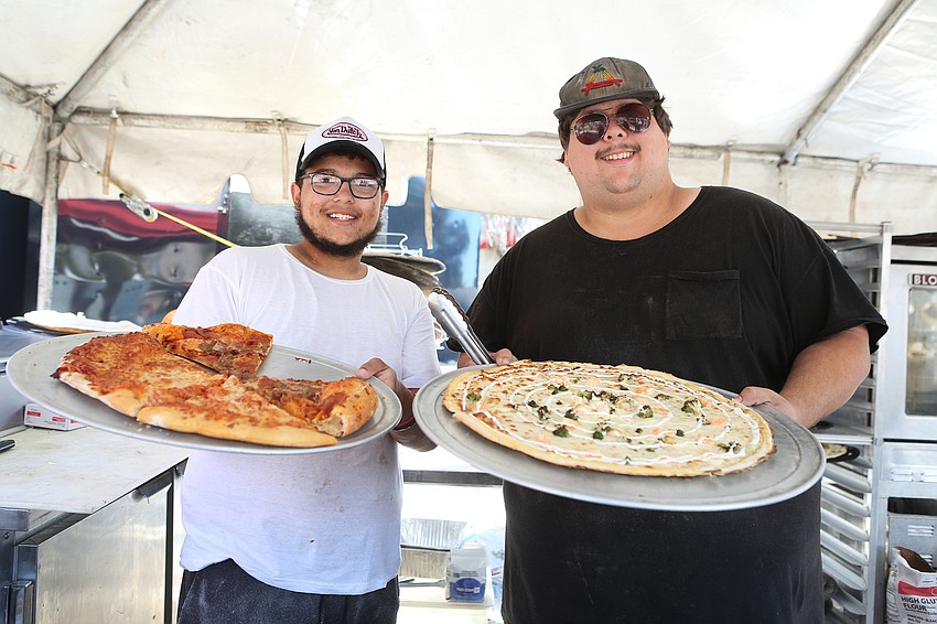 Mykel Blair and Siegel Barry offer up pizza.
