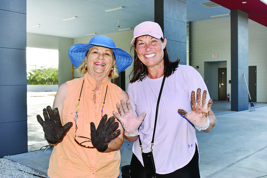 MAY: Carole Shawn and Nancy McLean show off their dirt-covered hands.