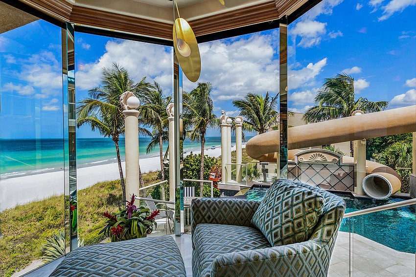 JUNE: The home for sale at 3105 Gulf of Mexico Drive has a waterslide from the roof.