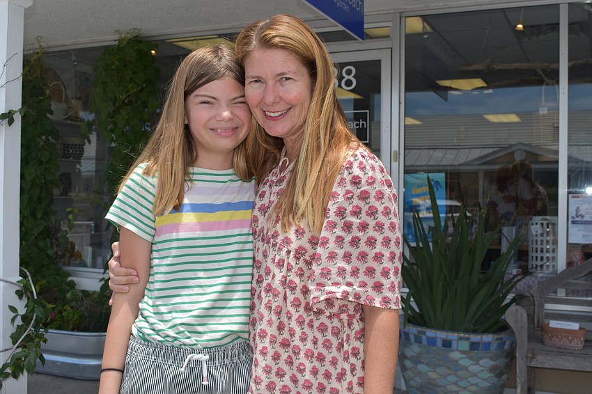 JULY: Lark and Heather Rippy pose for a picture inside the family's store. Driftwood Beach Home and Garden is located at 6838 Gulf of Mexico Drive.