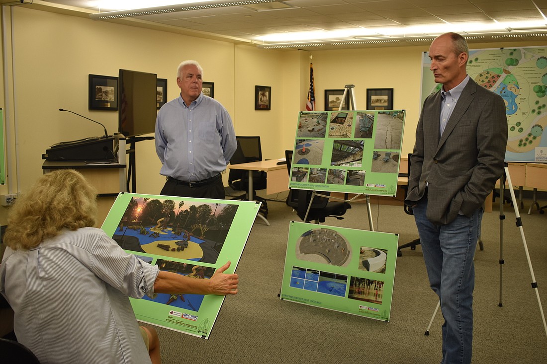 David W. Johnston Associates Landscape Architect Phillip Smith (left) and Jon F. Swift Construction President Jason Swift (right) present a rendering of the proposed park to a member of the public.