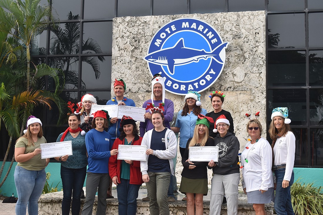 Members of Longboat Key Turtle Watch presented checks to Mote Marine Laboratory and Aquarium and Save Our Seabirds.