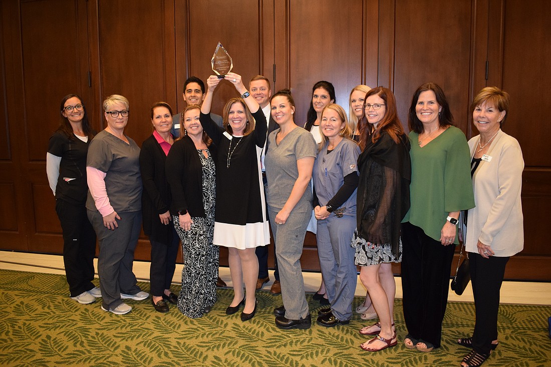 Members of the Lakewood Ranch Medical Center team show off their Humanitarian of the Year award from the Lakewood Ranch Community Fund. It was awarded at a Lakewood Ranch Business Alliance luncheon Dec. 8 at the Grove.