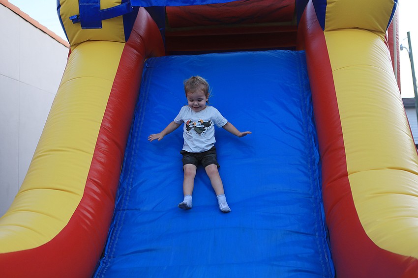 Finn Seth-Ard slides down the inflatable slide.