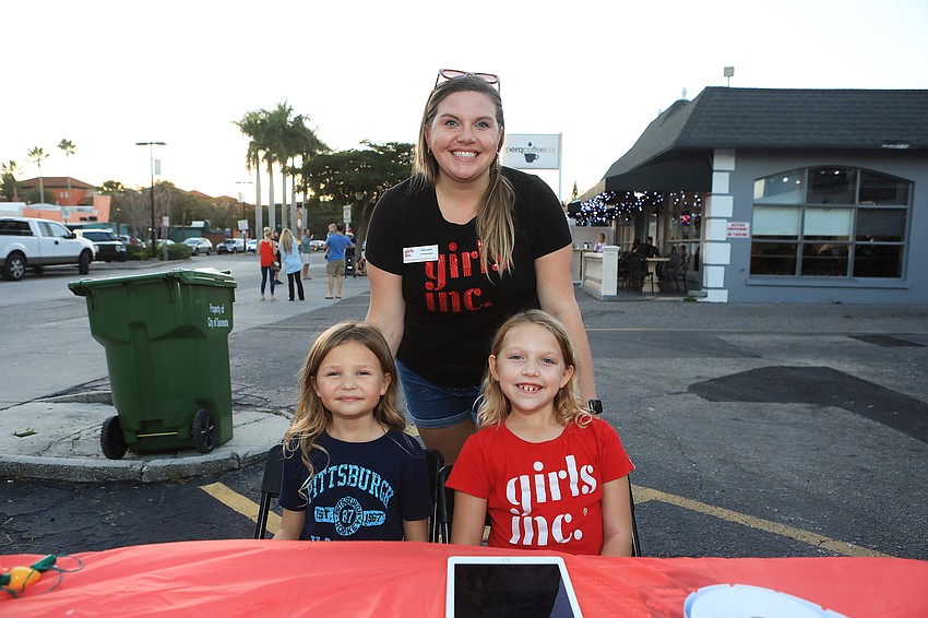 Ella Lewis, Josie Baldwin and Abby Lewis run the Girls, Inc. booth.