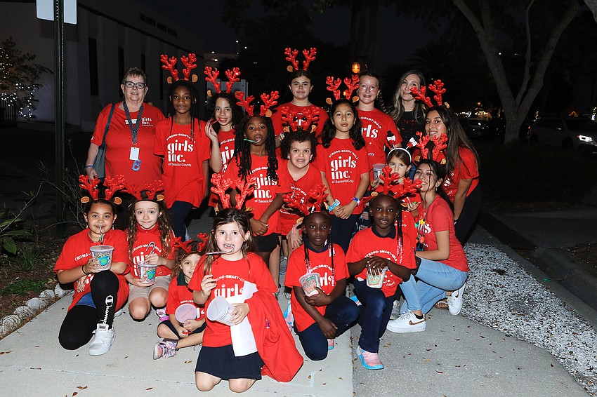 Girls Inc. members walk around caroling for guests.