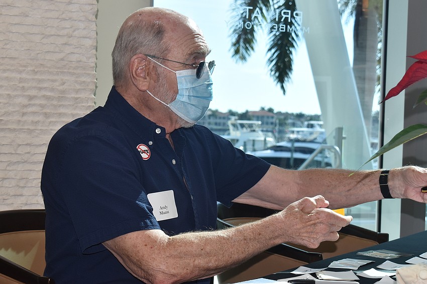 Andy Maass checks attendees in to the event.