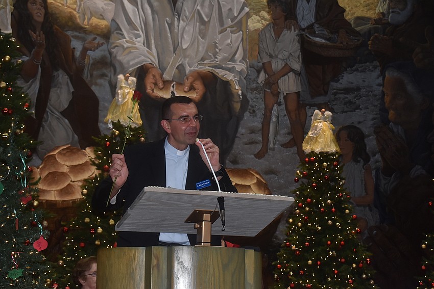 Rev. Robert Dziedziak speaks to his congregation during their Christmas concert.
