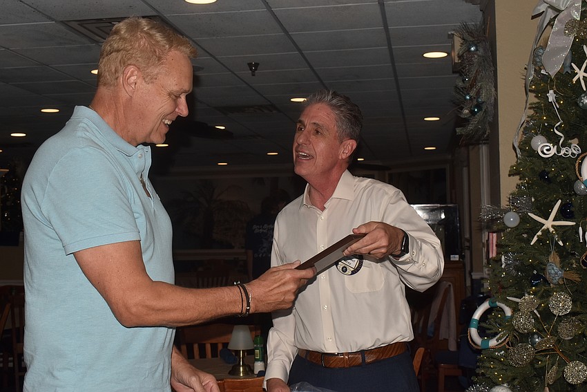 Michael Garey gave Chris Sachs a plaque for his bell ringing contributions.